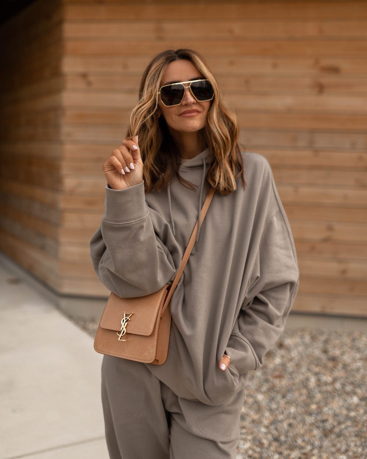 Karina wears grey calvin klein matching sweatpant and sweatshirt with ysl bag