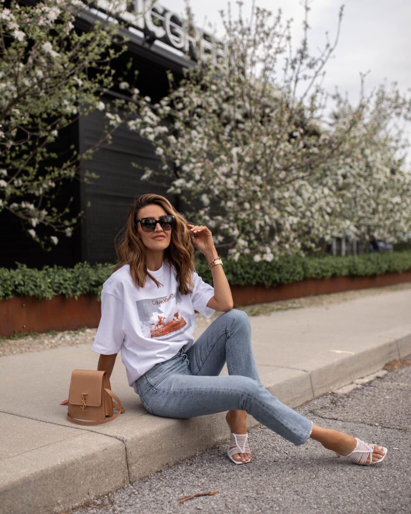 karina wears calving klein graphic tee with agolde jeans and ysl bag
