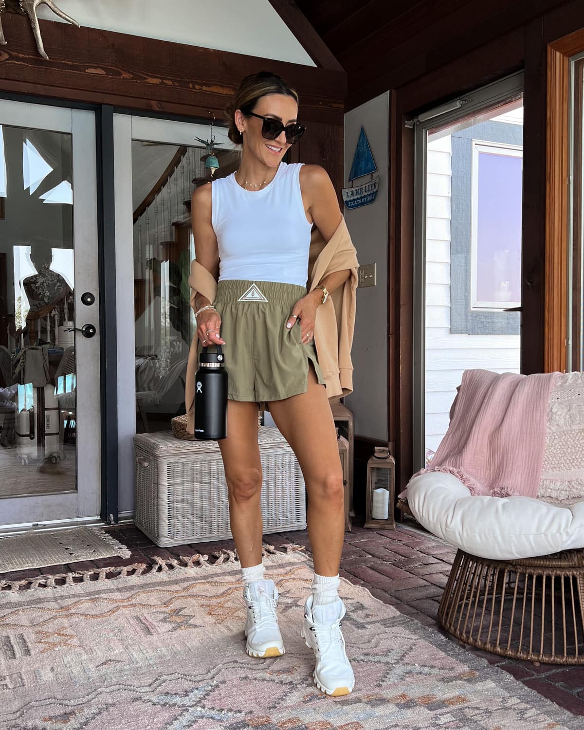 karina wears free people movement shorts with white tank and hiking boots