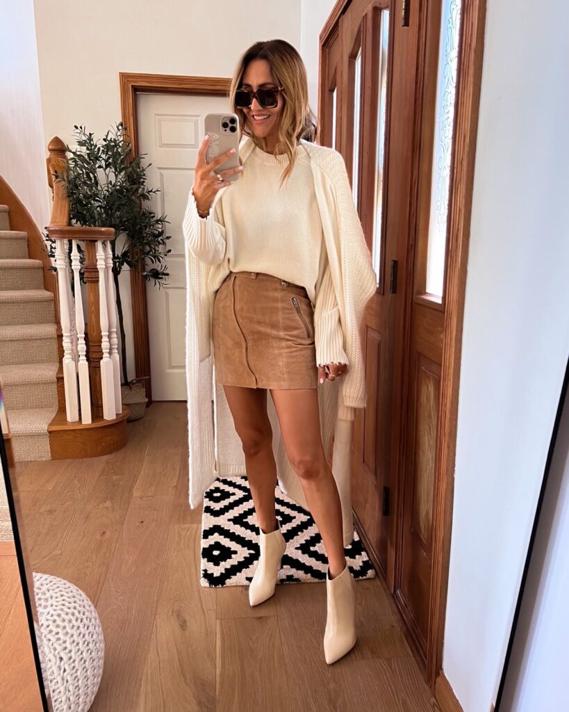 karina wears tan suede mini skirt with sweater and booties
