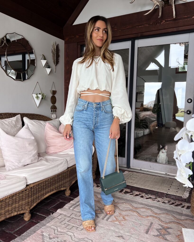 Karian wears rag and bone jeans with cropped blouse
