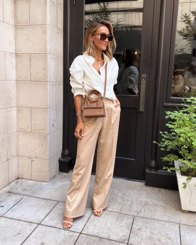 Karina wears white poplin button down with the favorite daught pant and jacquemus bag