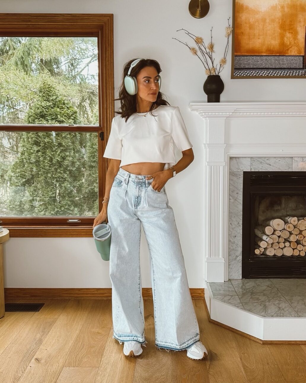 Karina wears Express wide leg jeans with cropped white tee