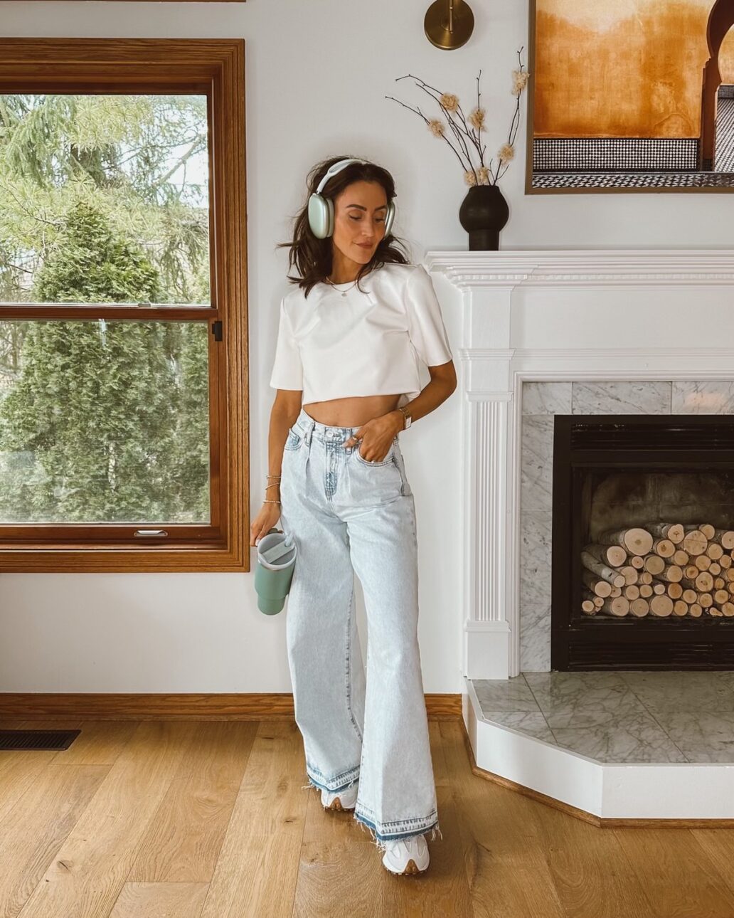 Karina wears Express wide leg jeans with cropped white tee