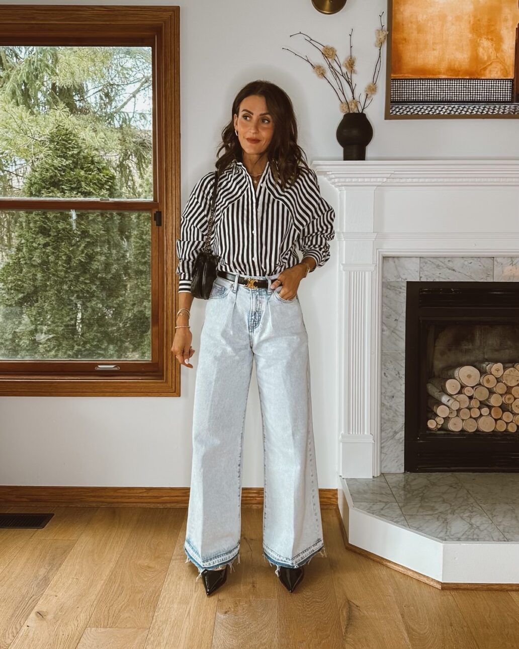 Karina wears Express wide leg jeans with striped button down shirt