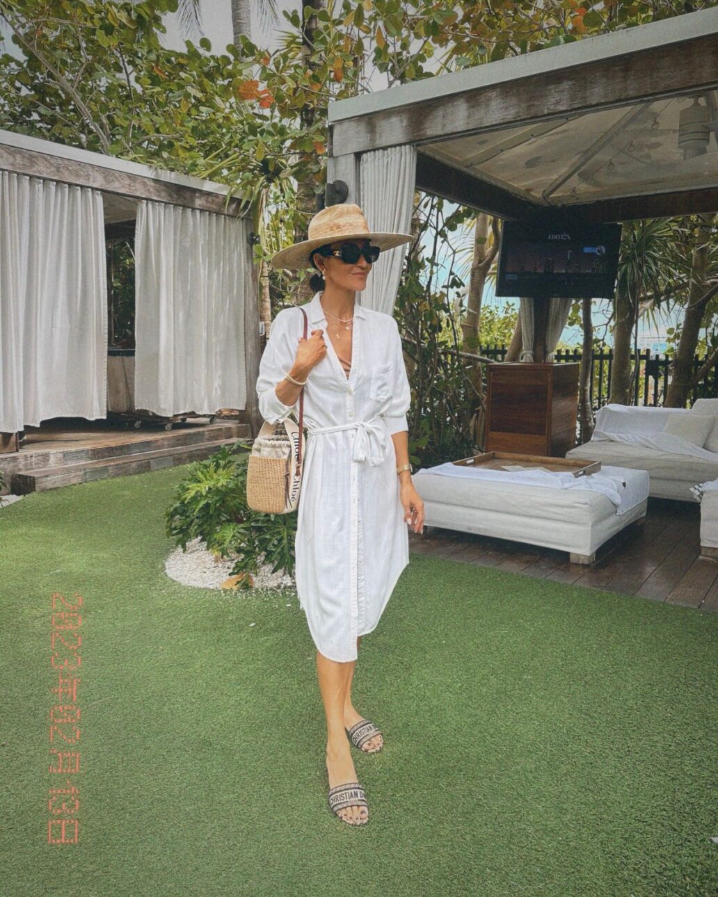 Karina wears white L'Space cover up with Lack of Color sun hat and Dior dway slides