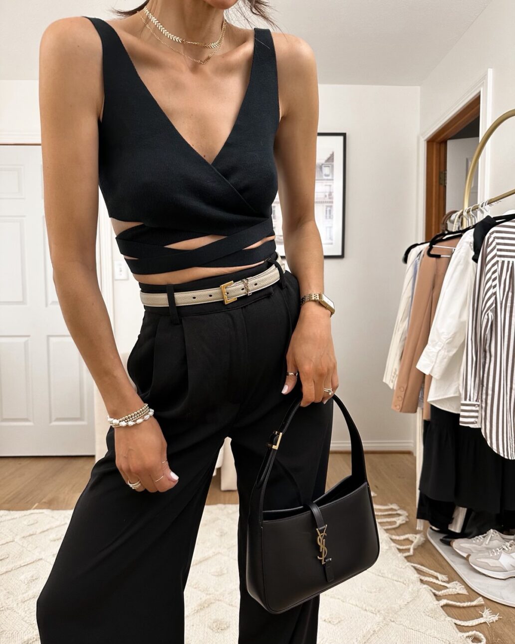 Karina wears Amazon black wrap cropped top with Amazon black trousers with YSL handbag