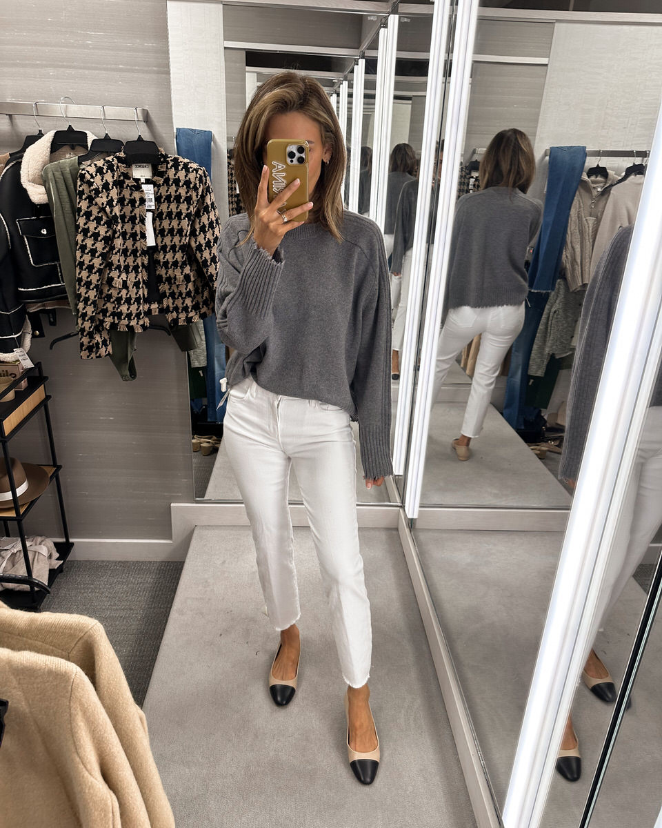 Crewneck grey sweater styled with white slim cut jeans and steve madden ballet flats 