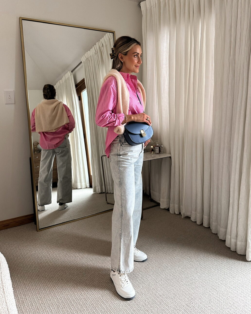 sezane button up pink shirt with light wash denim and white sneakers