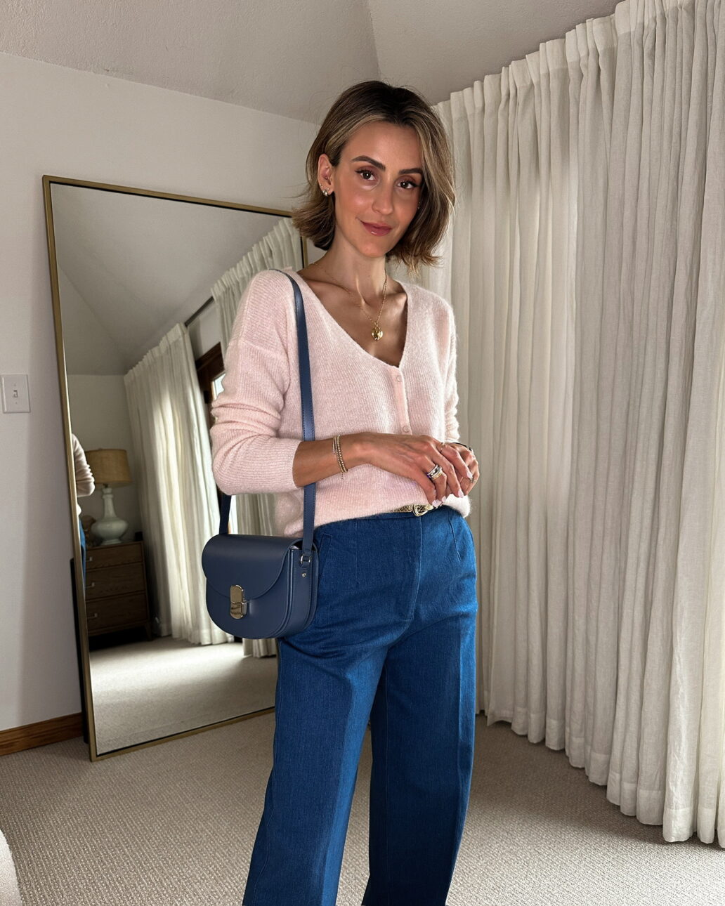 sezane light pink cardigan with blue trousers
