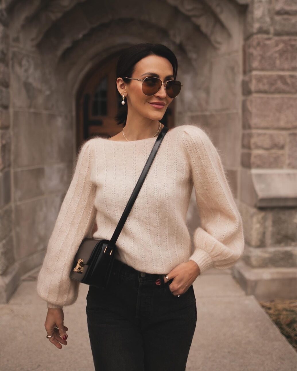 black jean outfit with a cream colored sweater