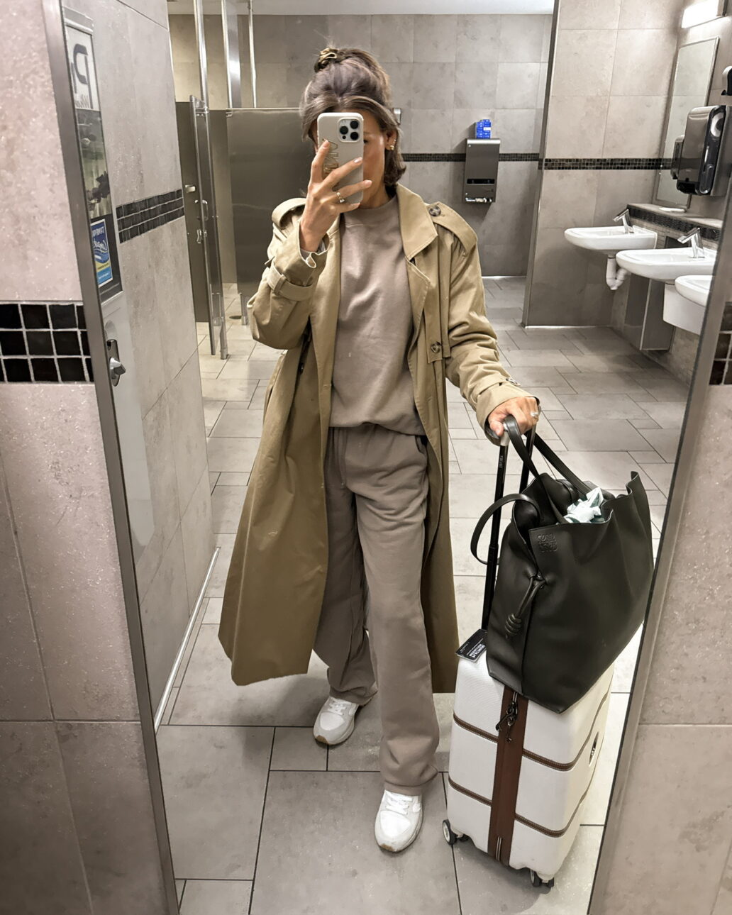 travel outfit for going on a ski trip - trench coat with a loungewear set and white sneakers