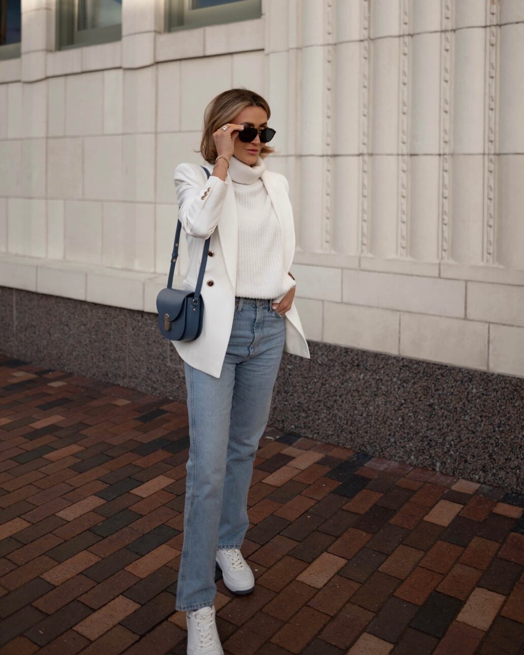 white sweater and white blazer with denim and white sneakers