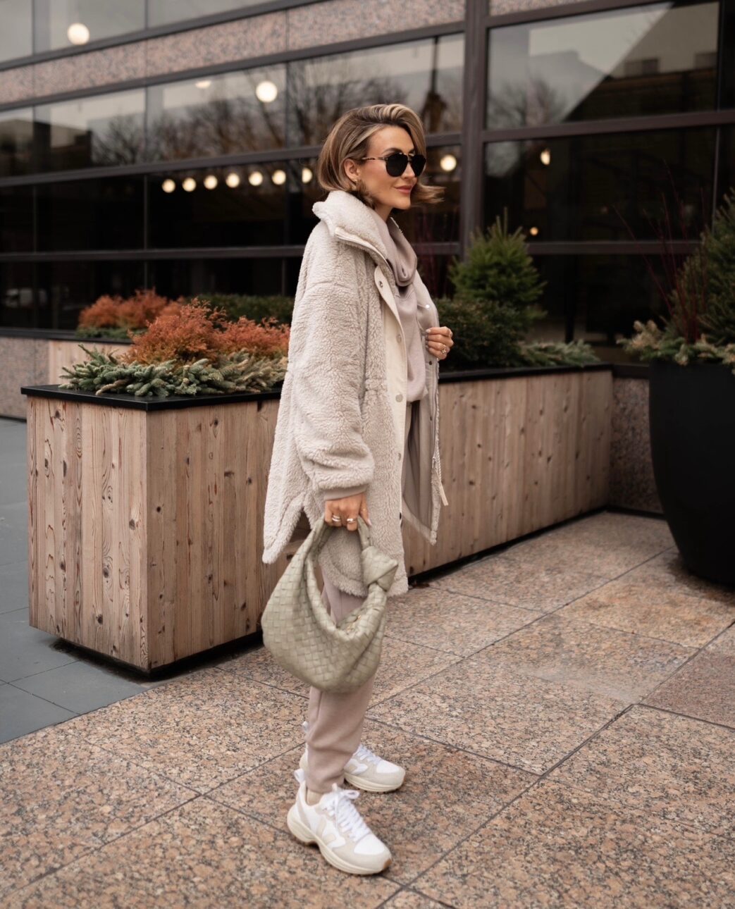 white sneaker outfit with a taupe loungewear set and a sherpa jacket