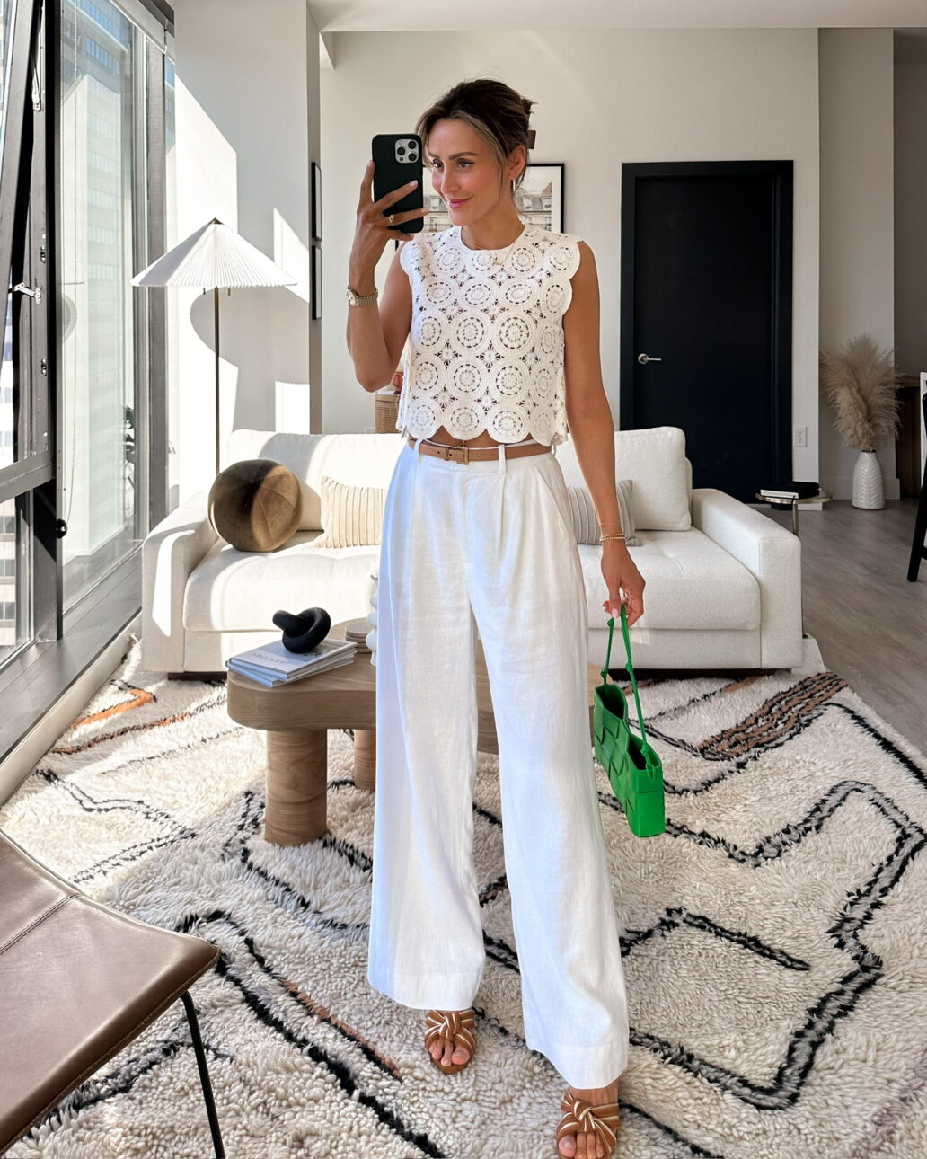 trouser outfit idea with a belt, white tank top and heels
