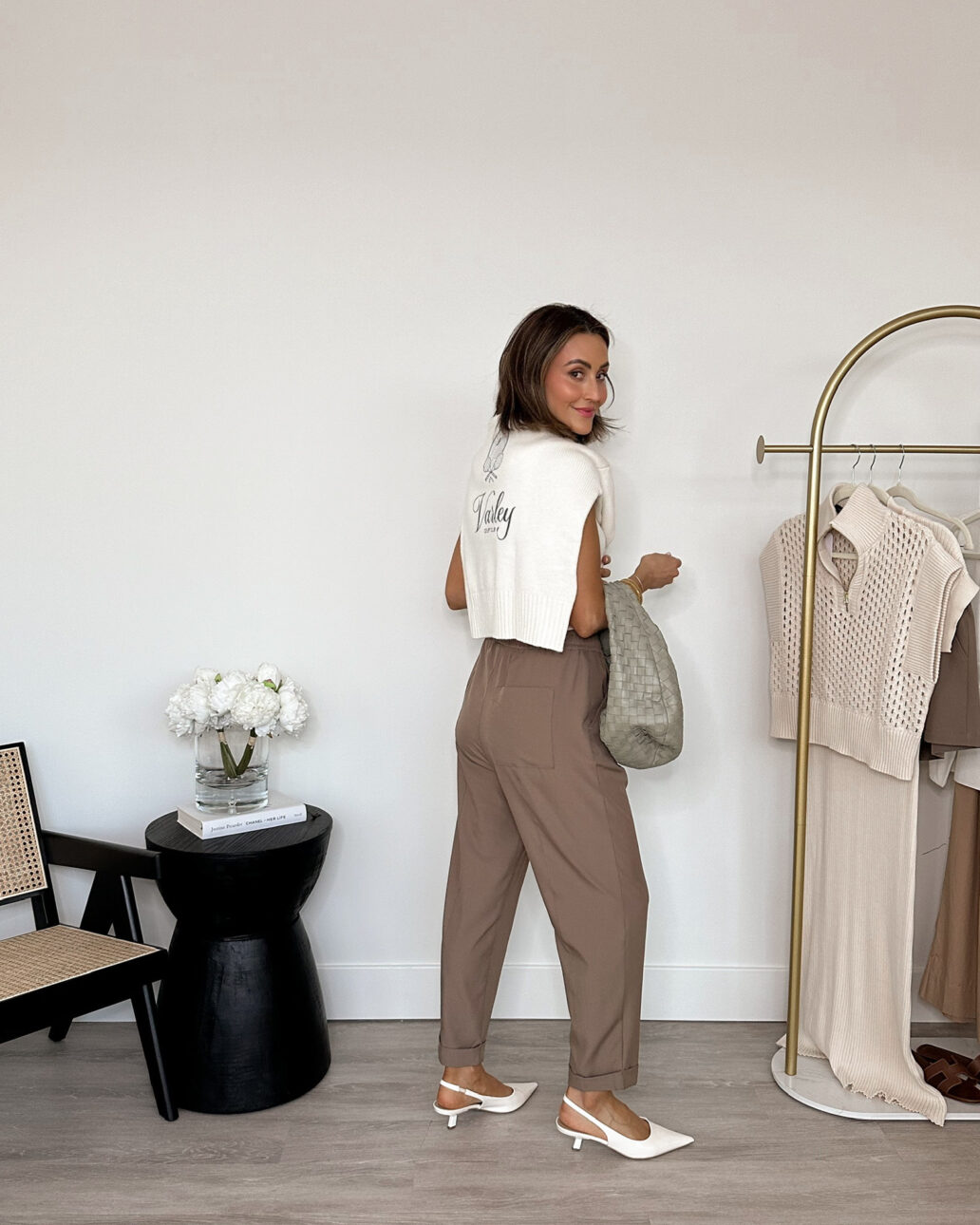 varley taper pants with heels, a white t-shirt, and a sweater