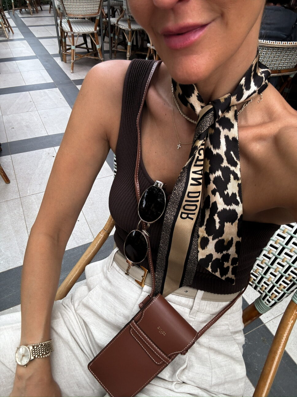 brown tank top with trousers and a silk neck scarf