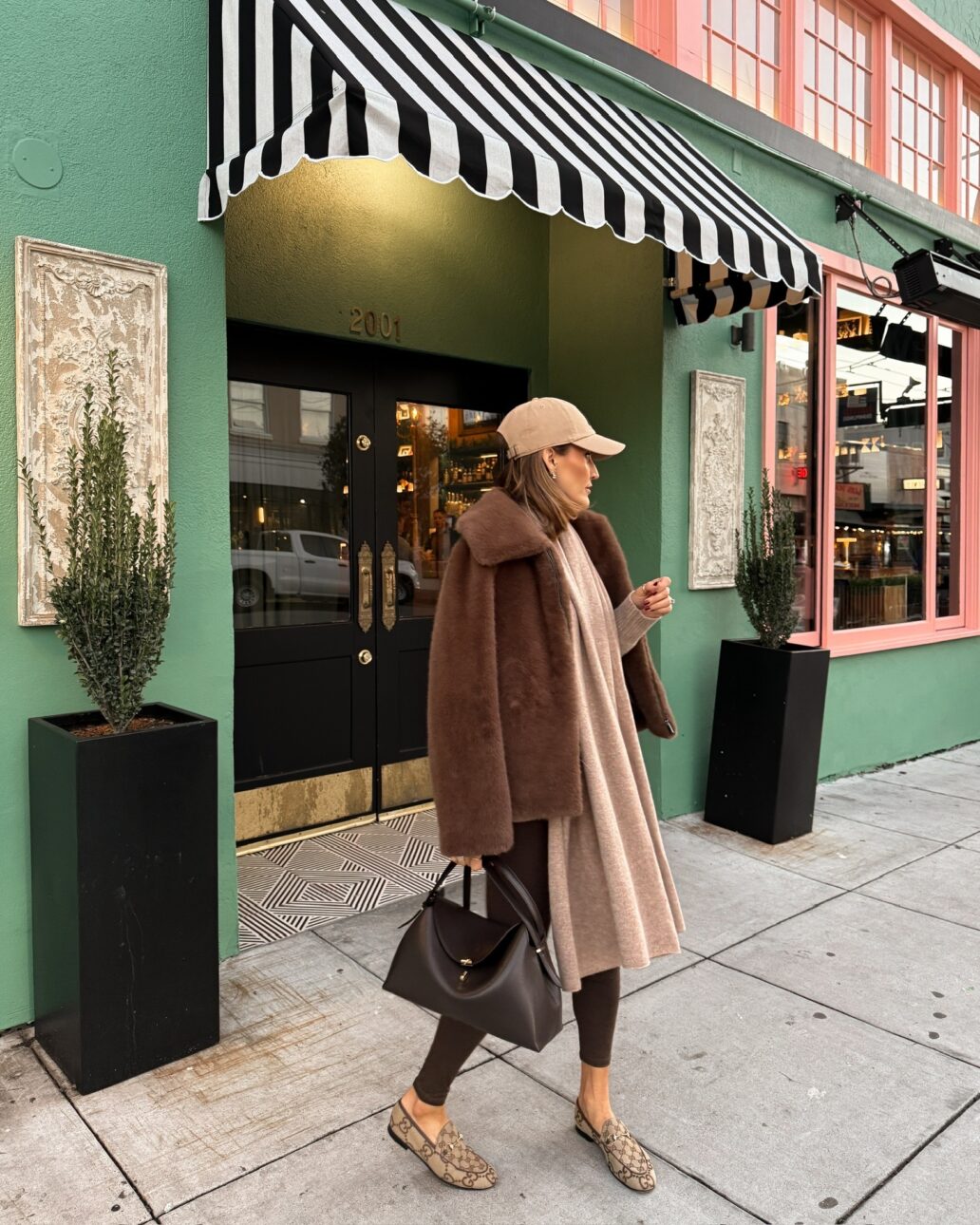 What to Wear Wine Tasting in the Winter Faux Fur Jacket with Loafers and a Hat