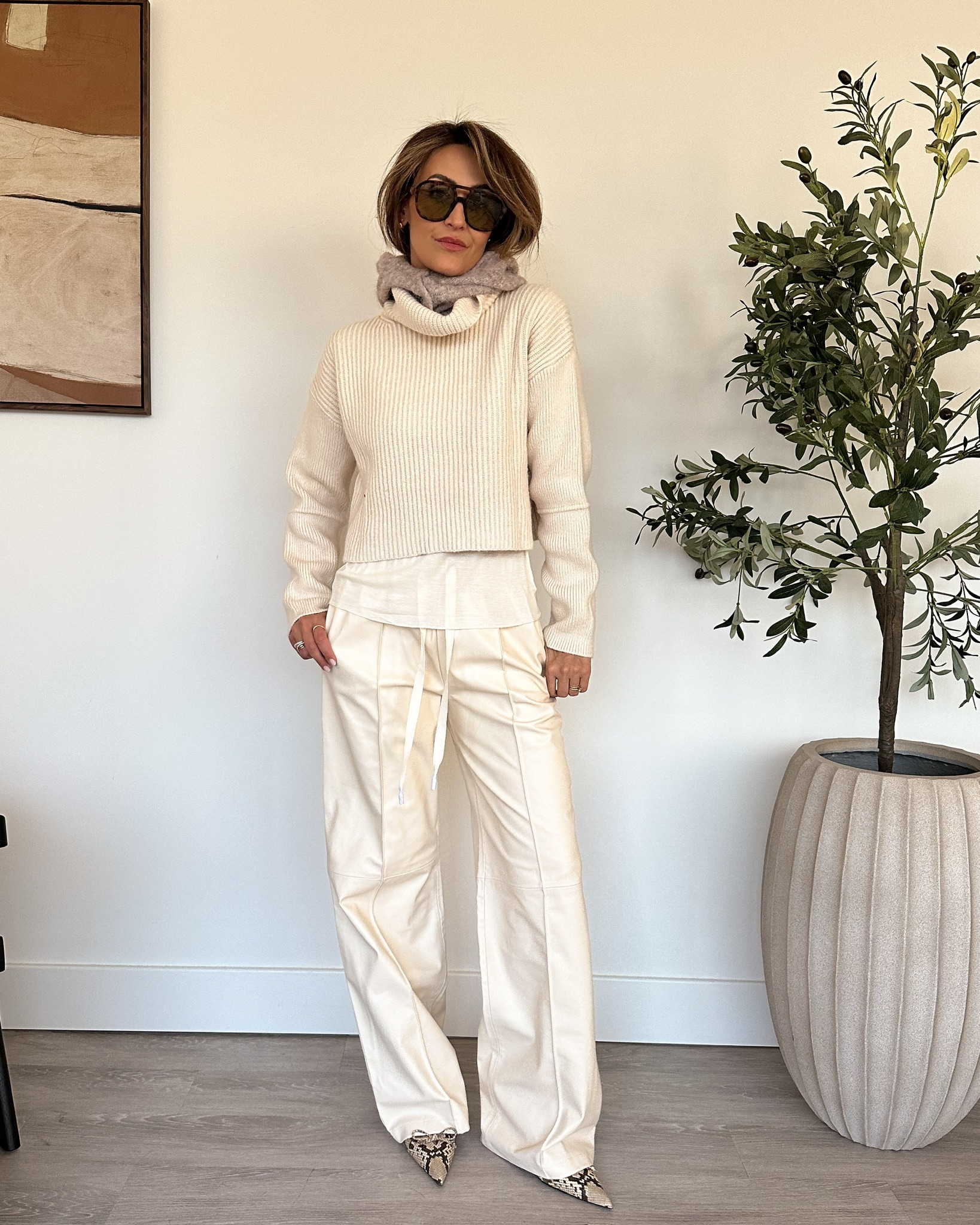 cream colored wide leg trousers with a sweater and heels