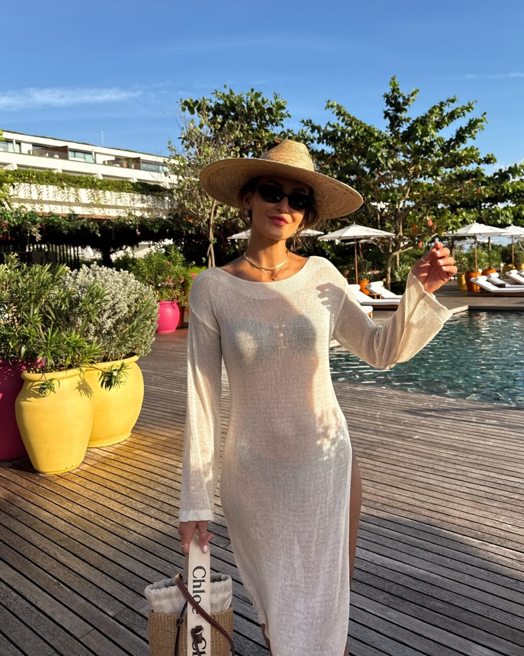 sheer cover-up dress with bikini, sun hat, sunglasses, and a straw basket bag