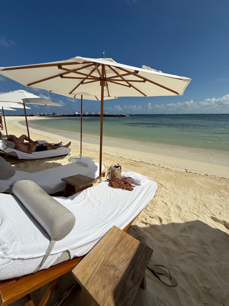 EDITION hotel riviera Maya beach front lounge chairs and umbrellas