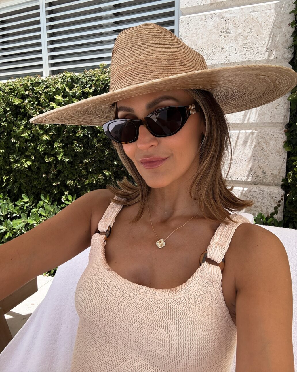one piece swimsuit with a sun hat and sunglasses