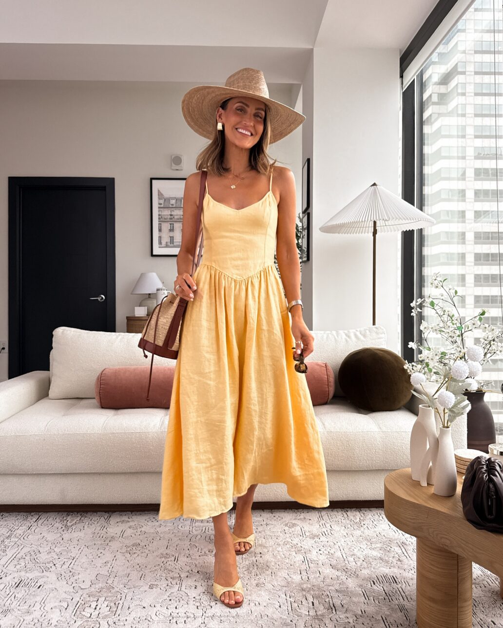 Butter yellow midi dress with heels and a straw bucket bag