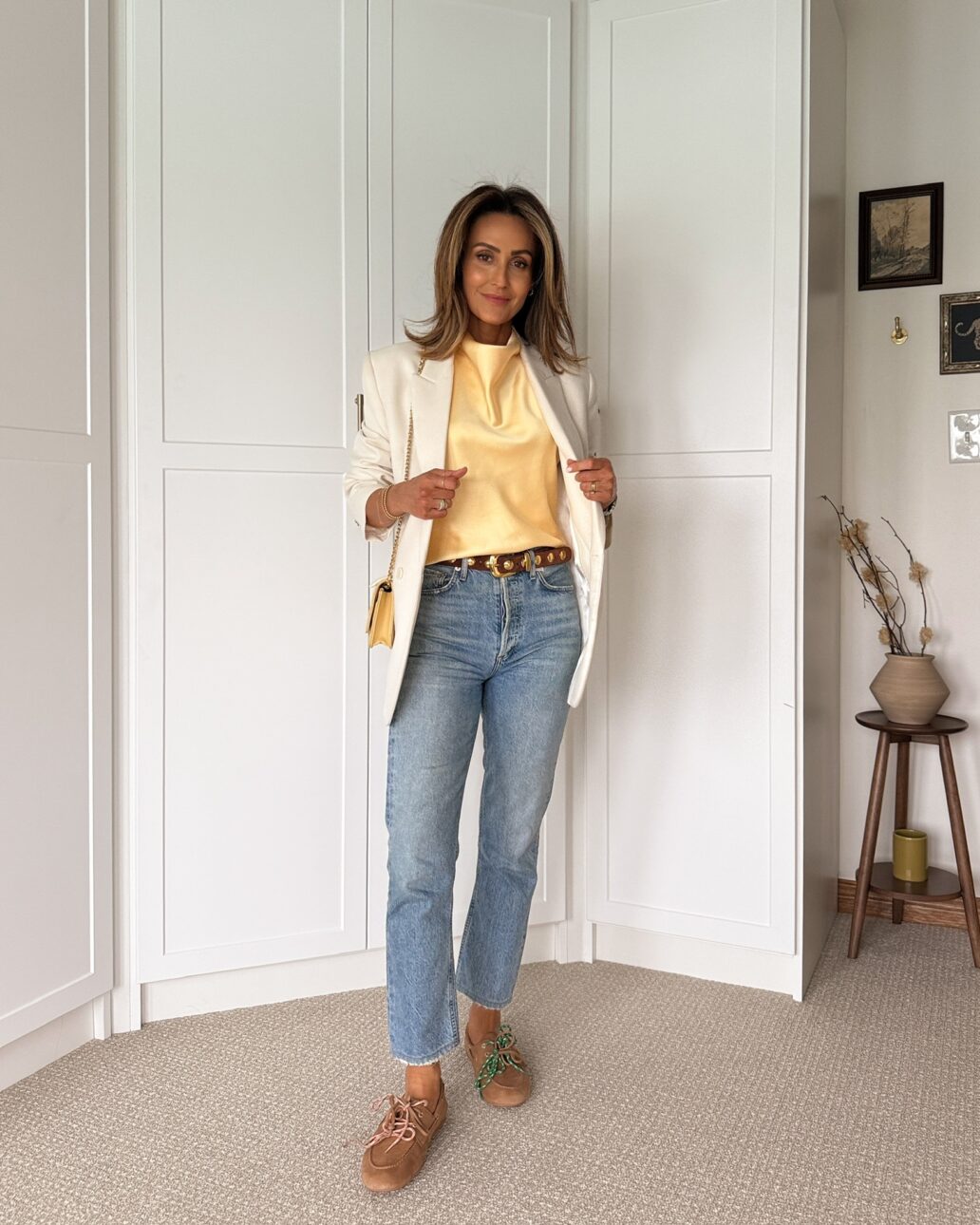 yellow silk top with straight leg jeans and a white blazer