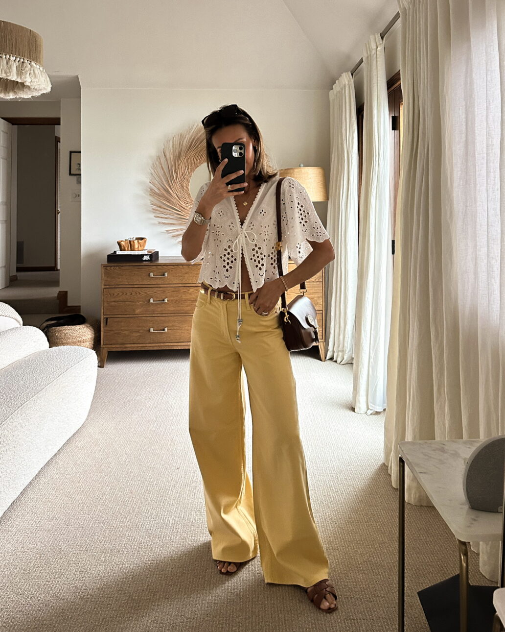 yellow wide leg jeans and a white lace top