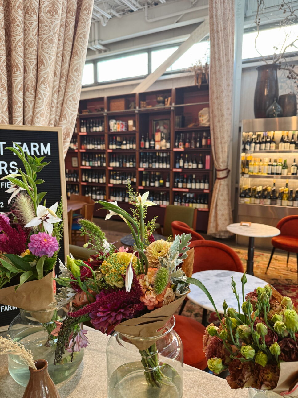 Wine bottles and flower arrangements at Little Saint Healdsburg